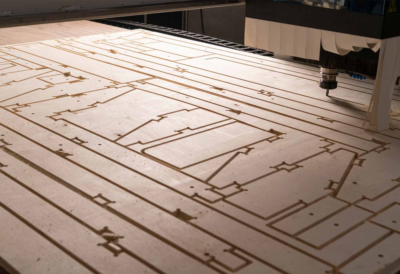 CNC router cutting nested sheet parts in a woodworking shop